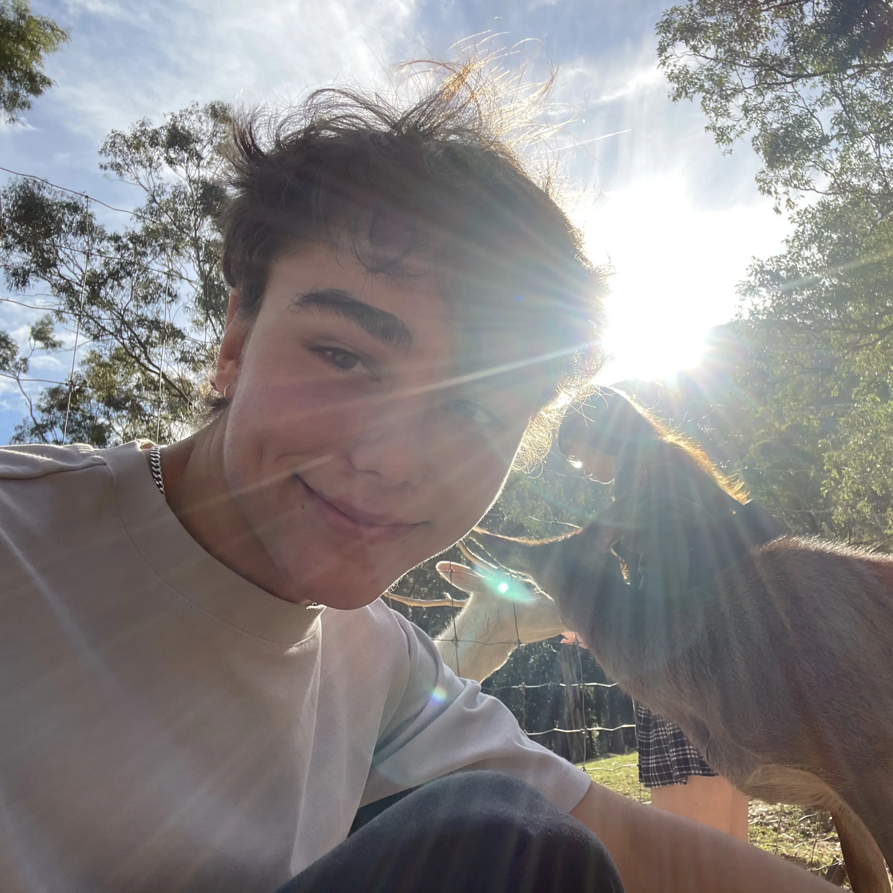 Photo of Levi Hunt in the foreground, with deer in the background.